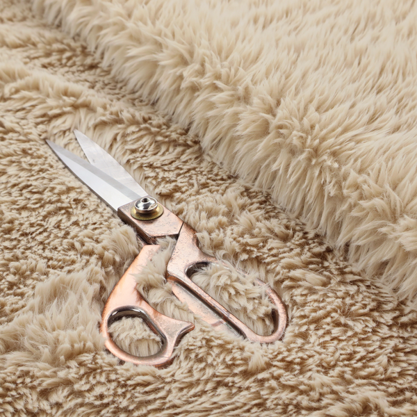 A tan or light beige, high-pile faux fur fabric. It has a dense, plush, and cosy texture with soft, slightly tousled fibres that create a shag-like appearance.