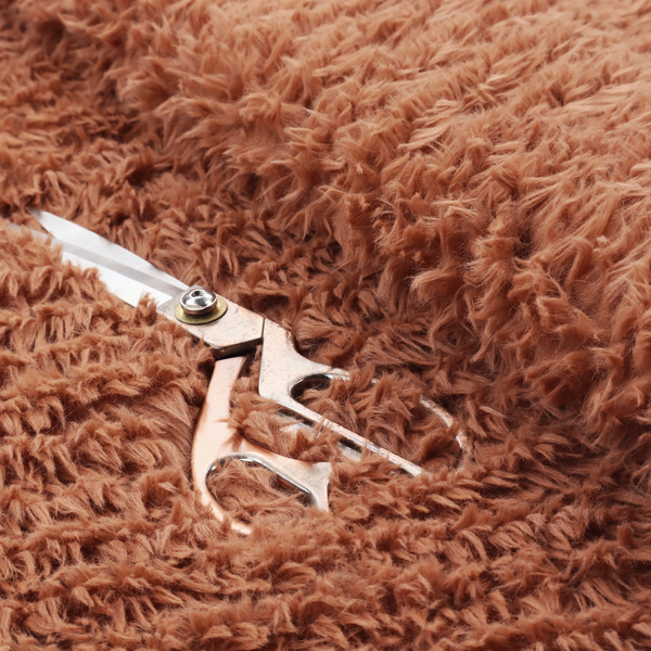 A rust or burnt-orange, high-pile faux fur fabric. It features a unique, wavy or rippled texture created by the directional alignment of the plush, soft fibres, giving it a distinctive shag-like appearance.