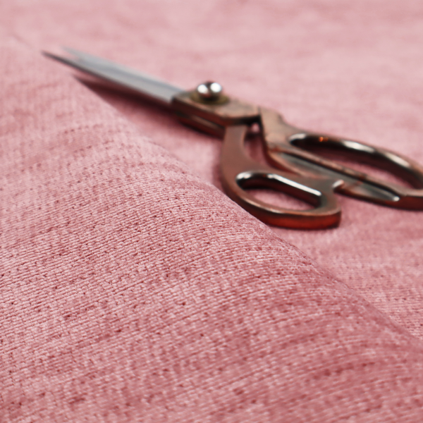 A vibrant mauve-pink or raspberry-toned fabric featuring a dense, horizontal corded texture. The soft, plush weave creates a uniform linear pattern with a subtle velvety sheen that catches the light along each ridge.