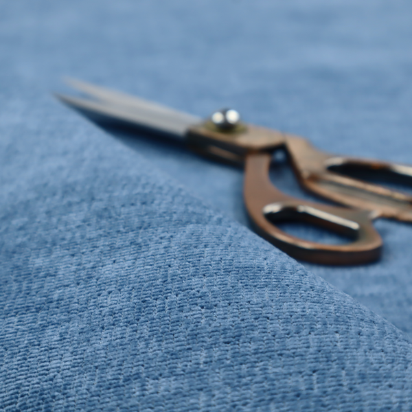 A vibrant mid-blue or cornflower blue fabric featuring a dense horizontal corded texture. The weave has a soft, plush finish with a subtle velvety sheen that creates light-catching highlights across the uniform linear ridges.