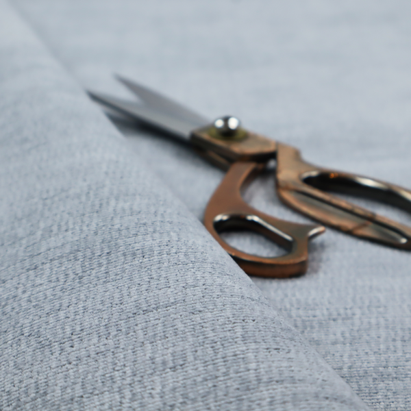 A slate grey fabric with a dense horizontal ribbed texture. The material features a plush, velvety pile with subtle mottled highlights, creating a rich, tactile surface that offers both depth and a modern, clean aesthetic.