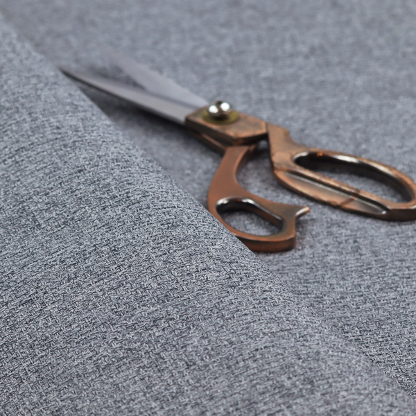 A fabric in a dark steel or charcoal grey. The high-contrast weave features interlaced light grey and deep black fibres, creating a rugged, textured surface.