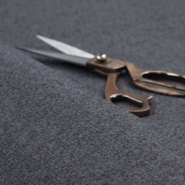 A fabric in a deep charcoal or carbon grey. The high-contrast weave features heavily interlaced black and slate grey fibres for a dense, rugged texture.