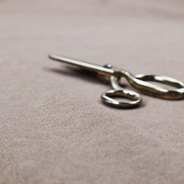 A taupe or mushroom-coloured fabric with a rich, distressed texture. The material features a fine, pebble-like grain combined with thin, irregular light-coloured "crackle" lines that mimic the look of aged leather or pressed felt. The colour is a sophisticated blend of dusty brown and grey tones with ivory highlights.