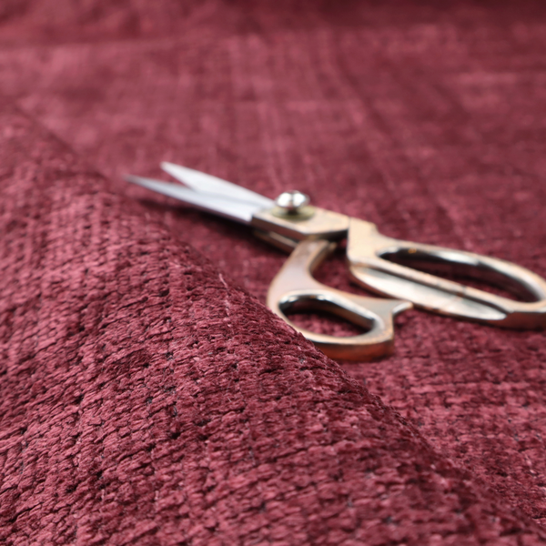 Scanno Weave upholstery fabric in a deep red shade, showcasing a detailed, woven texture with an interlocking grid pattern.