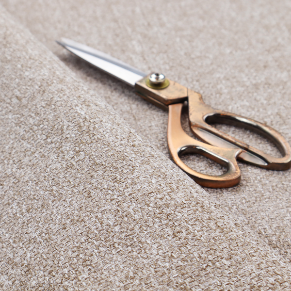 A Chamonix Water Repellent upholstery fabric in light brown. The material features a dense basket weave texture with oatmeal and cream tones and a durable, matte finish.