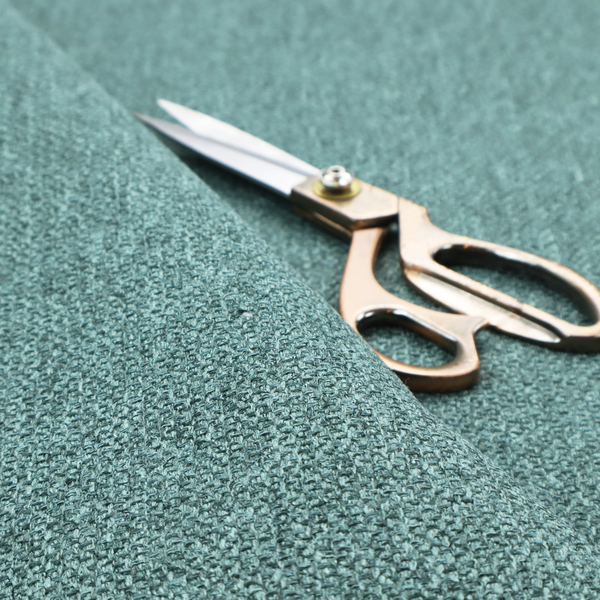 A Chamonix Water Repellent upholstery fabric in Emerald Green. The material features a dense, jewel-toned basket weave texture with a multi-tonal finish and a durable, matte look.