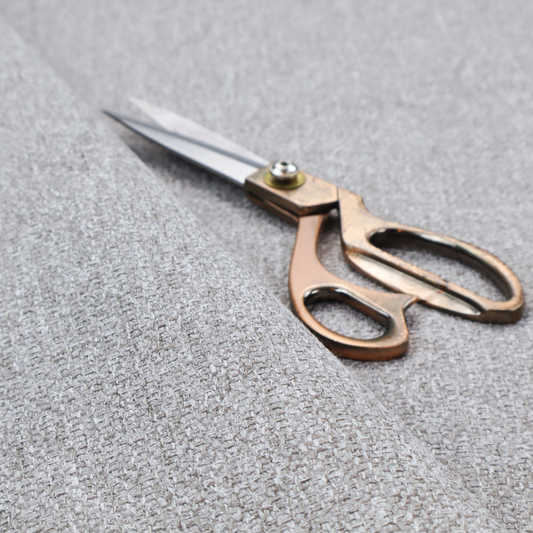 This weathered fabric blends charcoal and slate yarns with cool silver and off-white threads, resulting in a balanced, stony neutral that offers a modern and professional aesthetic.