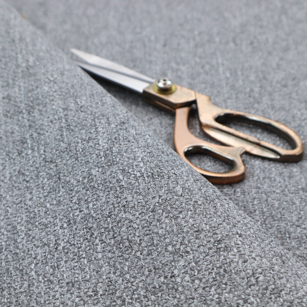 A versatile Mid Grey. This fabric features a classic "salt and pepper" effect, blending charcoal and light silver threads for a balanced, stony appearance that hides wear exceptionally well.