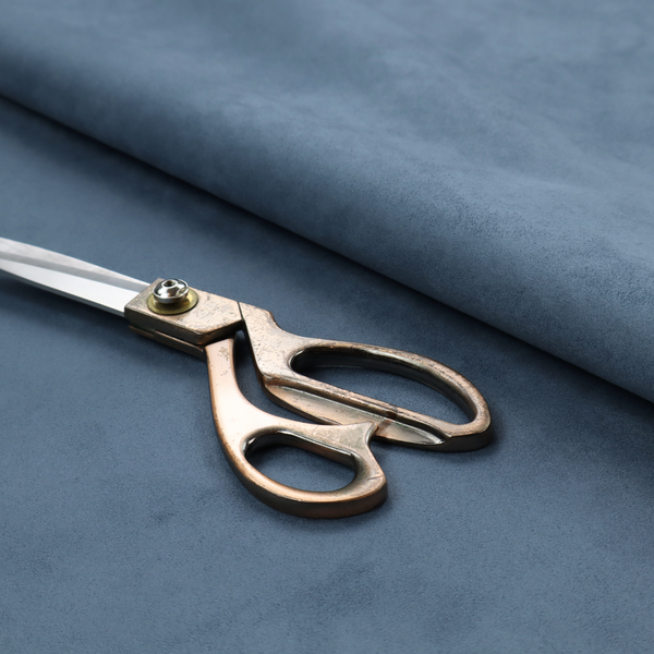 Annecy Water Repellent Velvet in Steel Blue. The fabric features a dense, plush pile with a soft matte finish in a sophisticated, mid-toned greyish-blue. This high-performance upholstery material offers a luxurious feel and a specialized water-resistant coating for superior durability and a calm, modern look.