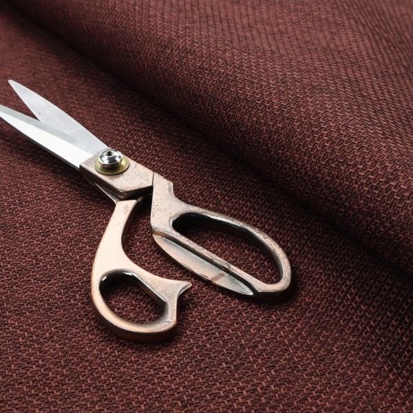 A tightly woven fabric in a deep, rich burgundy or dark maroon shade, featuring a distinct, structured basket-weave pattern.