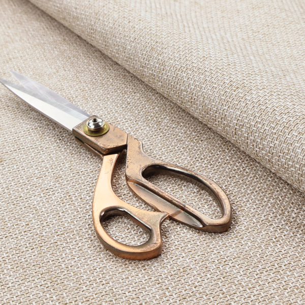 A tightly woven fabric in a soft, neutral cream or off-white shade, featuring a distinct, structured basket-weave pattern.