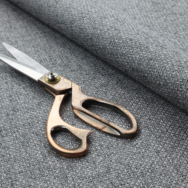 A durable, woven upholstery fabric featuring a monochromatic, heathered grey colour scheme. The weave is tight and consistent, characterized by an intricate, interlocking pattern of light, medium, and dark grey yarns that create a subtle, textured visual effect.