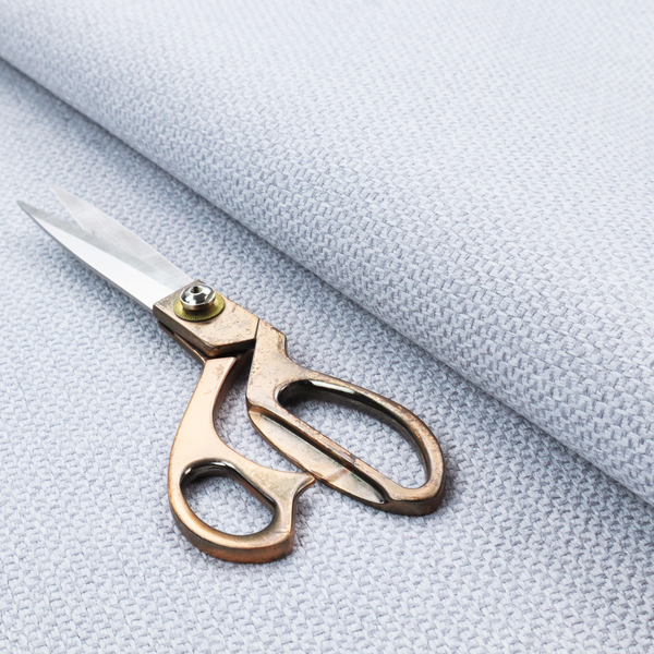 This fabric features a tight, structured basket weave in a sophisticated, cool-toned silver.