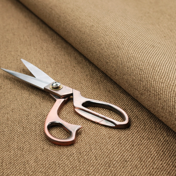 A golden-brown upholstery fabric with a dense, diagonal textured weave.