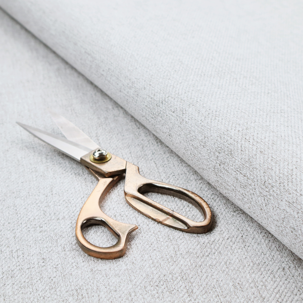 A light grey upholstery fabric with a fine, dense textured weave.
