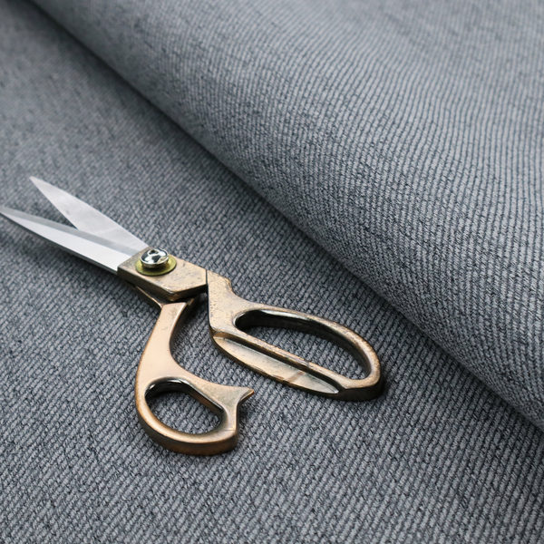 A charcoal grey upholstery fabric with a dense, diagonal textured weave.