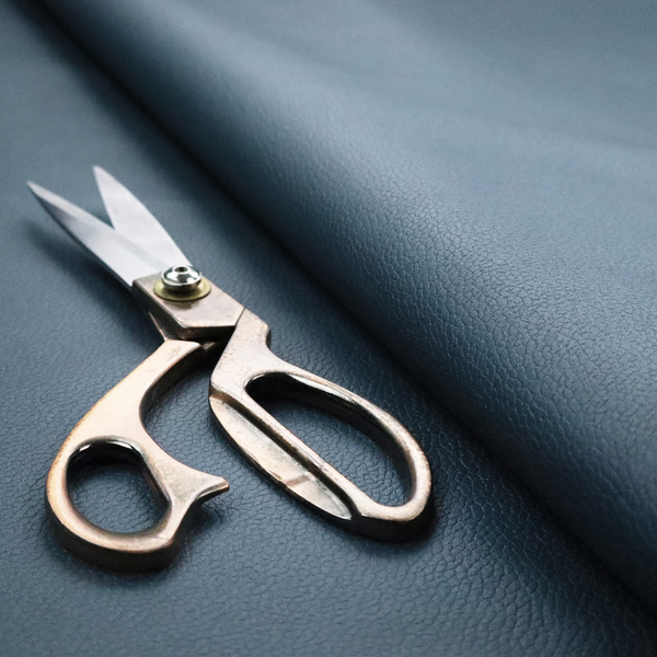 Boston Faux Leather Upholstery Fabric in a slate blue colour, showcasing a fine pebbled grain texture.