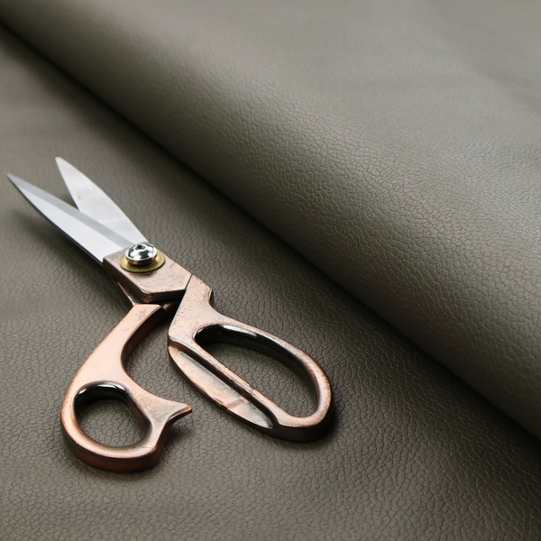 Boston Faux Leather Upholstery Fabric in a deep olive green colour, showcasing a fine pebbled grain texture.