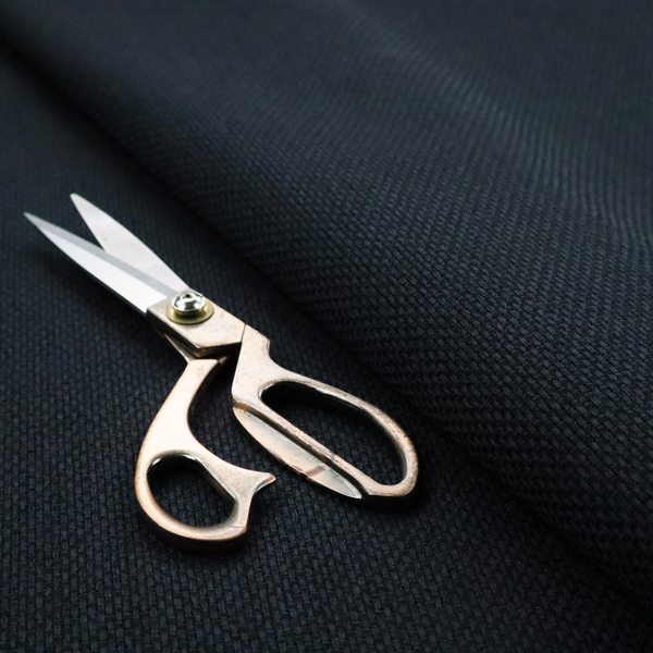 A deep midnight-black or ink-black fabric featuring a distinct, tightly woven grid texture. The material showcases a rich, multi-tonal, basket-weave style pattern with interlaced charcoal and solid black threads, creating a dramatic, subtle, and matte finish across the entire surface.