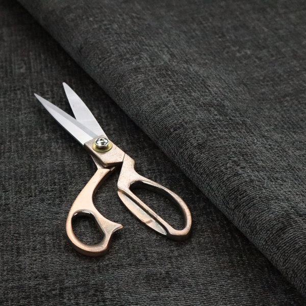 A textured fabric swatch in a very dark anthracite or charcoal grey colour. The material features a dense, uniform nubby weave with deep, almost black shading variations, creating a rich, moody, and sophisticated appearance.