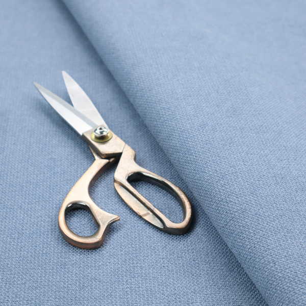A textured cornflower blue fabric with a tight, uniform cross-weave.