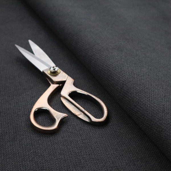 A textured near-black fabric with a tight, uniform cross-weave.