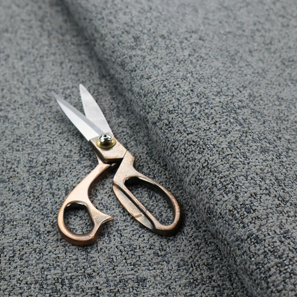 A multi-tonal grey and charcoal textured woven fabric swatch.
