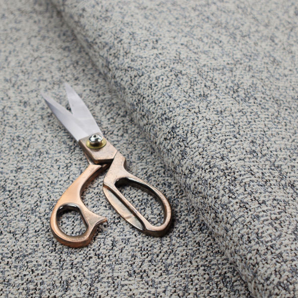 A multi-tonal light grey and cream textured woven fabric swatch.