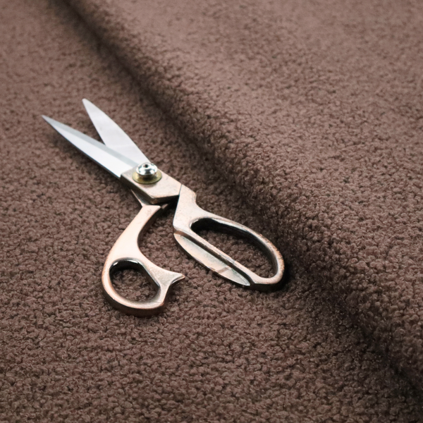 A textured chocolate brown bouclé upholstery fabric.