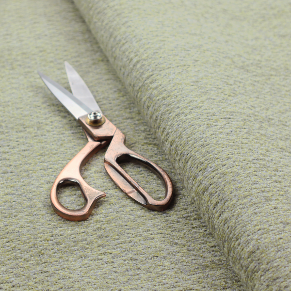 A multi-toned chartreuse green and grey textured upholstery fabric.