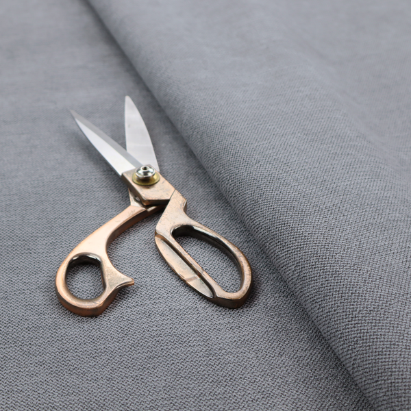 A finely textured weave in a medium mineral grey or cool slate shade. The material features a subtle heathered look with finely blended threads of classic grey, white, and faint charcoal undertones throughout.