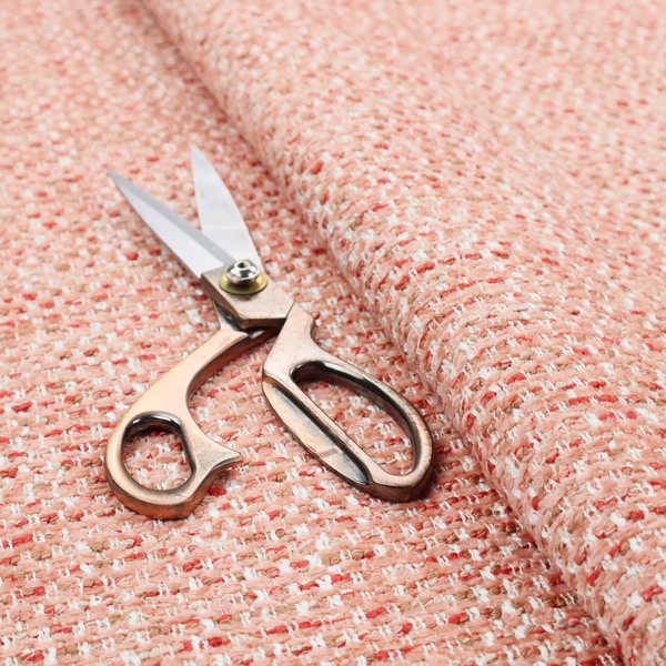 The material features a dense, warm-toned weave with a soft coral pink and peach base, intricately interlaced with horizontal flecks of terracotta red, beige, and white threads throughout.