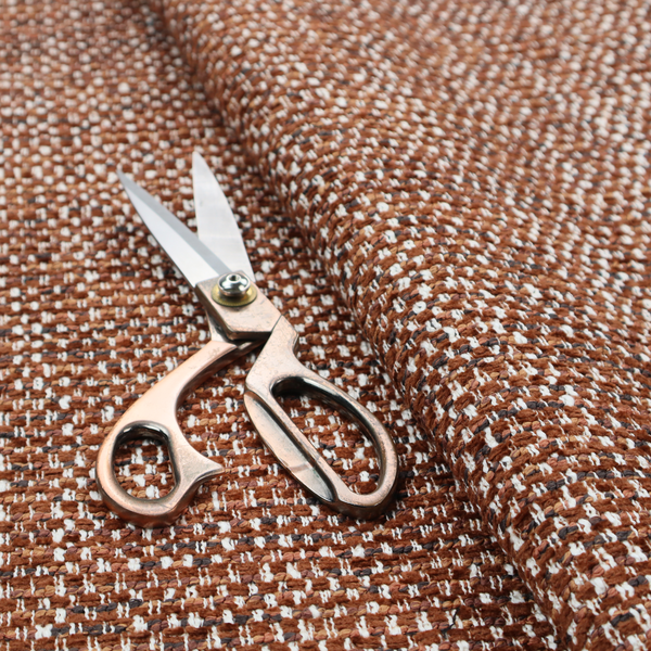 The material features a dense, multi-toned weave with a warm rust orange and terracotta base, intricately interlaced with prominent horizontal flecks of crisp white and dark charcoal brown threads throughout.