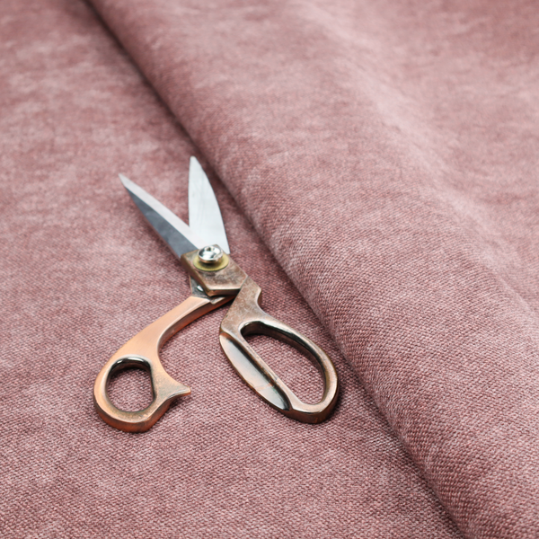 A fine, woven upholstery fabric in a deep, muted mauve or dusky rose tone, featuring a consistent and textured surface pattern.