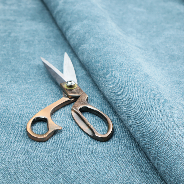 A fine, woven upholstery fabric in a bright, refreshing sky blue tone, featuring a consistent and textured surface pattern.