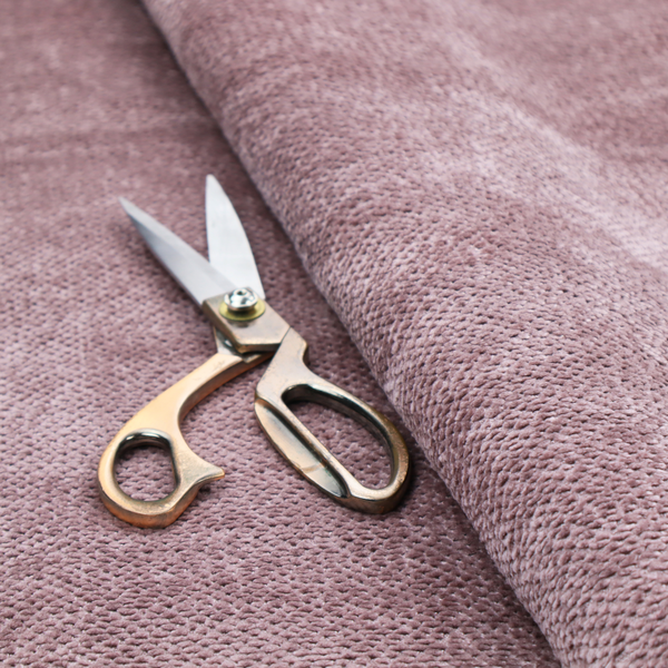 A muted, dusty rose or soft mauve upholstery fabric. It maintains the signature dense, uniform, boucle-style weave seen in the previous samples, featuring small, looped, and nubby yarn fibres that create a soft and tactile surface.