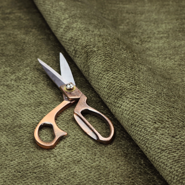 A deep, earth-toned olive green upholstery fabric. It continues the signature dense, uniform, boucle-style weave of the collection, created with small, looped, and nubby yarn fibres that offer a soft and tactile surface.