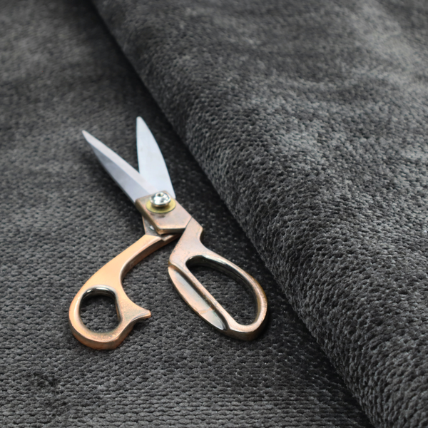 A deep, dark charcoal or near-black upholstery fabric. It maintains the signature dense, uniform, boucle-style weave of the collection, characterized by small, looped, and nubby yarn fibres that provide a soft and tactile surface.