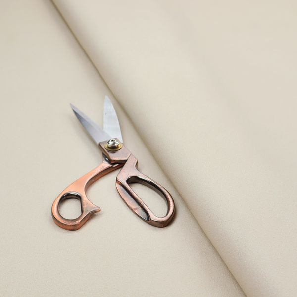 A solid champagne-coloured Hallstatt faux leather fabric texture with a smooth, fine finish.