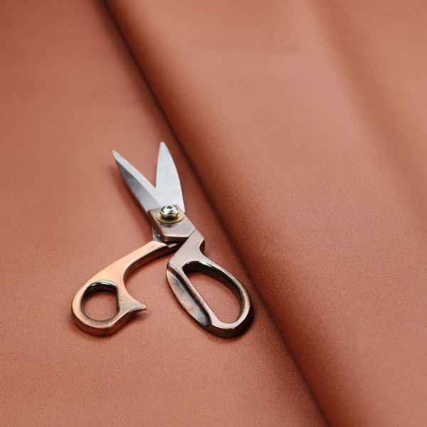 A solid rust-coloured Hallstatt faux leather fabric texture with a smooth, fine finish.
