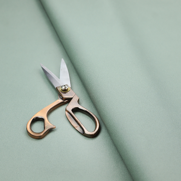 A solid sage green-coloured Hallstatt faux leather fabric texture with a smooth, fine finish.