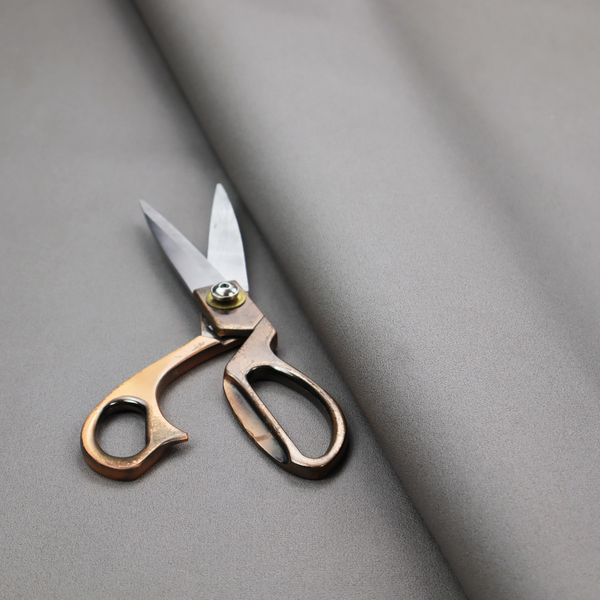 Plain, solid warm grey-coloured Hallstatt faux leather fabric texture with a smooth, fine finish.
