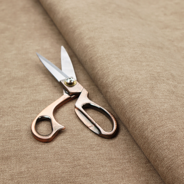 A solid light brown or taupe woven textile with a fine, subtle textured weave.
