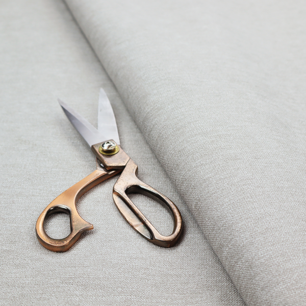 A light grey or silver woven textile with a fine, subtle textured weave.