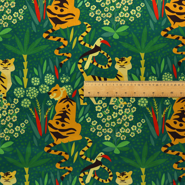 A detailed tropical jungle pattern fabric featuring illustrated yellow and black tigers, birds with red beaks, palm trees, and small white flowers on a deep green background.