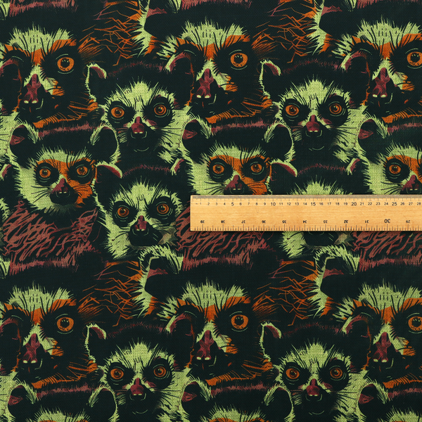 Fabric pattern featuring a repeating, illustrated design of lemur faces in lime green, orange, and dark brown.