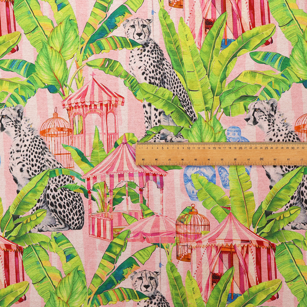 Pink striped fabric with a repeating pattern of seated cheetahs, tropical banana palm leaves, pink striped pavilions, birdcages, and blue porcelain ginger jars.