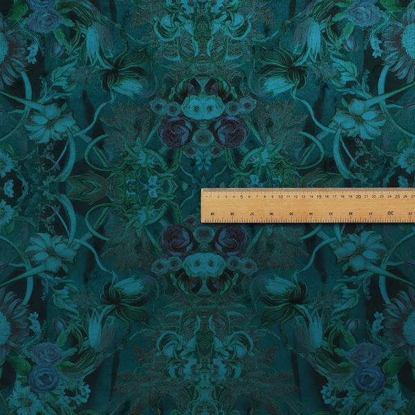 A symmetrical, damask-style botanical fabric pattern in deep teal and turquoise tones, featuring an intricate mirror-image design of large sunflowers, roses, swirling vines, and leafy foliage against a dark, textured background.