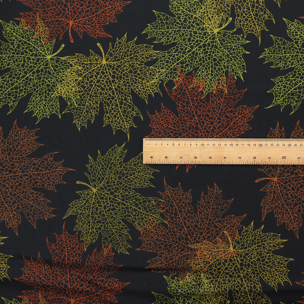 An autumn botanical fabric pattern featuring detailed skeleton maple leaf outlines in rust red, olive green, and gold on a black background.